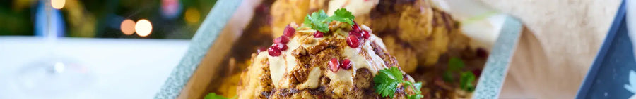 Whole Roasted Harissa Cauliflower with Hummus Dressing