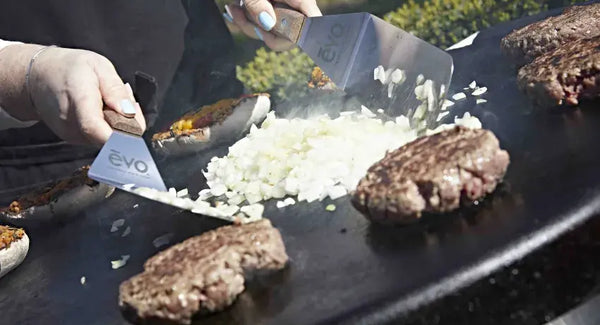 Cooking burgers and onions on the AGA Professional Series Outdoor Grill